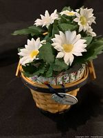 Longaberger miniature basket set with white daisy floral arrangement inside, displayed from front
