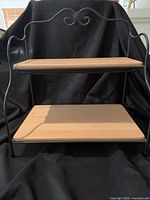 Front view of Longaberger bakers’ rack showing two maple shelves and iron frame.