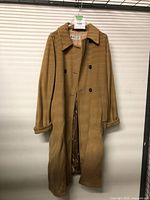 Full front view of camel colored Marella women's coat hanging, showing long length, double-breasted button front, collar, and pockets.