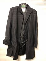 Front view of the men's black coat showing the notch lapel collar and shoulder construction.