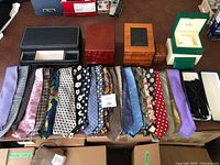 Overall view of all ties laid out in front of watch boxes