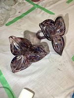 Pair of hand-blown art glass trillium flowers showing colors and shape from above.