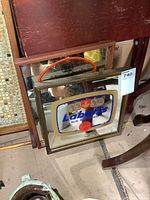 Two vintage bar mirrors stacked, wood frames, one featuring Labatt's beer advertisement