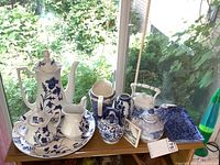 Overview of all blue and white porcelain pieces on a windowsill