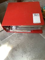 Top view of large red binder filled with comic books in plastic sleeves