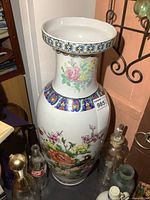 Full view of the porcelain vase showing flared rim and floral bird artwork.