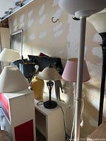 Overview of assorted lamps including floor and table lamps with different shades and bases