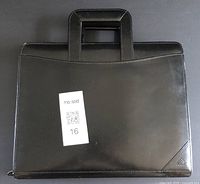 Front view of black leather case with retractable handles and visible zipper, showing clean surface with minor wear marks and a MaxSold tag.