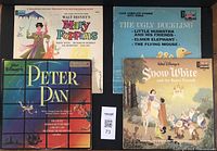 Top-down photo showing all four Disneyland Records vinyl LP albums: Mary Poppins, Peter Pan, Snow White and the Seven Dwarfs, and The Ugly Duckling. Covers and their colors and designs are clearly visible.