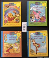 Front covers of four Disney Pooh Bear books Volumes 1 to 4 from 1996 Out & About with Pooh series.