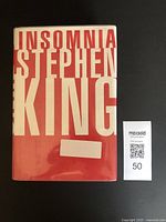 Front cover of Insomnia by Stephen King showing title and author on red and white dust jacket.