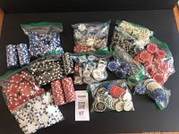 Overview of the collection of poker chips in various plastic bags, showing an assortment of colors and some stacked chips.
