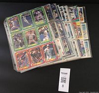 Binder pages showing multiple Toronto Blue Jays baseball cards from various manufacturers in protective sleeves.