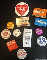Front view of all 11 vintage political election buttons arranged on a black background showing campaign slogans and candidate names.