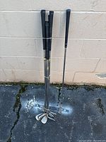 Eight Callaway golf clubs bundled together, showing grips and club heads.
