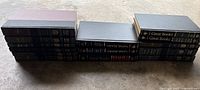Photo showing an arrangement of 16 black hardcover volumes from the Great Books collection with gold text.