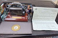 UPS 90th Anniversary diecast truck in original display case with certificate and letter on wooden surface