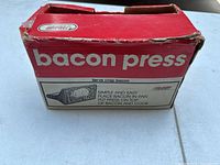 Original box of the bacon press showing branding and usage instructions.