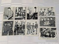 Eight Beatles trading cards laid out
