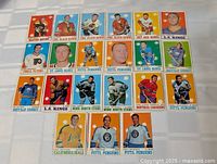 Full layout of 21 vintage O-Pee-Chee cards, four rows on table