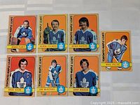 Seven Toronto Maple Leafs 1972-73 O-Pee-Chee hockey cards laid out on table
