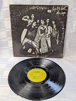 Front cover with vinyl record displaying yellow-green Warner Bros. label