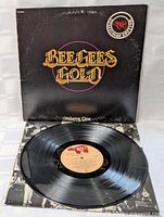 Record on inner sleeve beside open jacket front