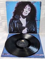 Front of jacket and vinyl record on display