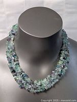 Front view of twisted jade chip necklace on display bust