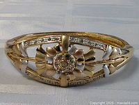 Front view showing floral motif and rhinestones