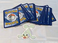 Stack of Pokémon card backs with Seel sticker