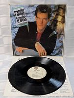 Front cover, vinyl record, and printed inner sleeve displayed