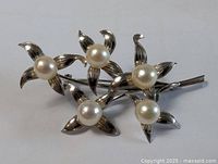 Full view of brooch front showing all five pearl-centered flowers