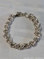 Full view of sterling silver bracelet showing overall design and clasp