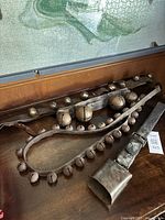 All three bell straps laid out on wooden surface