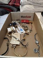 Cardboard tray with six wristwatches, three rosaries and two loose crosses