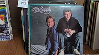 Photo showing a vinyl LP album by Air Supply with two men posing on cover.