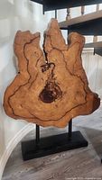 Front view of the wood slab art piece on stand