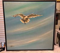 Front view of large framed painting showing seagull and signature