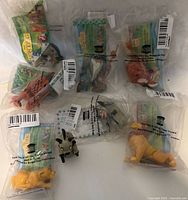 Seven Lion King character toys in original Burger King packaging plus one loose toy outside packaging