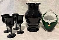 Full lot showing 4 black wine glasses, amethyst vase, and Murano glass basket with sticker.