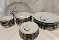 Full view of stacked dinnerware set showing dinner plates, salad plates, soup bowls, bread plates