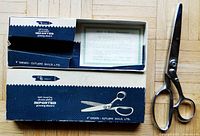 Pinking shears with original blue and white box showing product illustrations and printed text "belt bearing chrome alloy imported pinking shears"