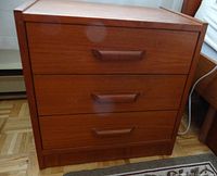 Front view showing three drawers and integrated handles
