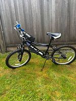 Side view of the CCM children's bike showing overall condition, frame, and attachments such as bag and bell.