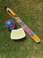 Set with Umbro soccer ball, white step stool, and packaged kite on grass