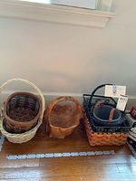 Five baskets arranged on floor showing variety of sizes and styles.