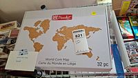Full front view of the closed original box showing the cork map world map in 32 pieces and MAKE Market branding