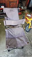 Gray Ford Explorer folding camping chair showing stitched logo on backrest and seat detail.