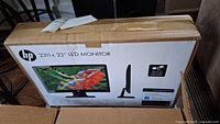 Box showing HP logo and image of 23-inch LED monitor model 2311x with colorful display image